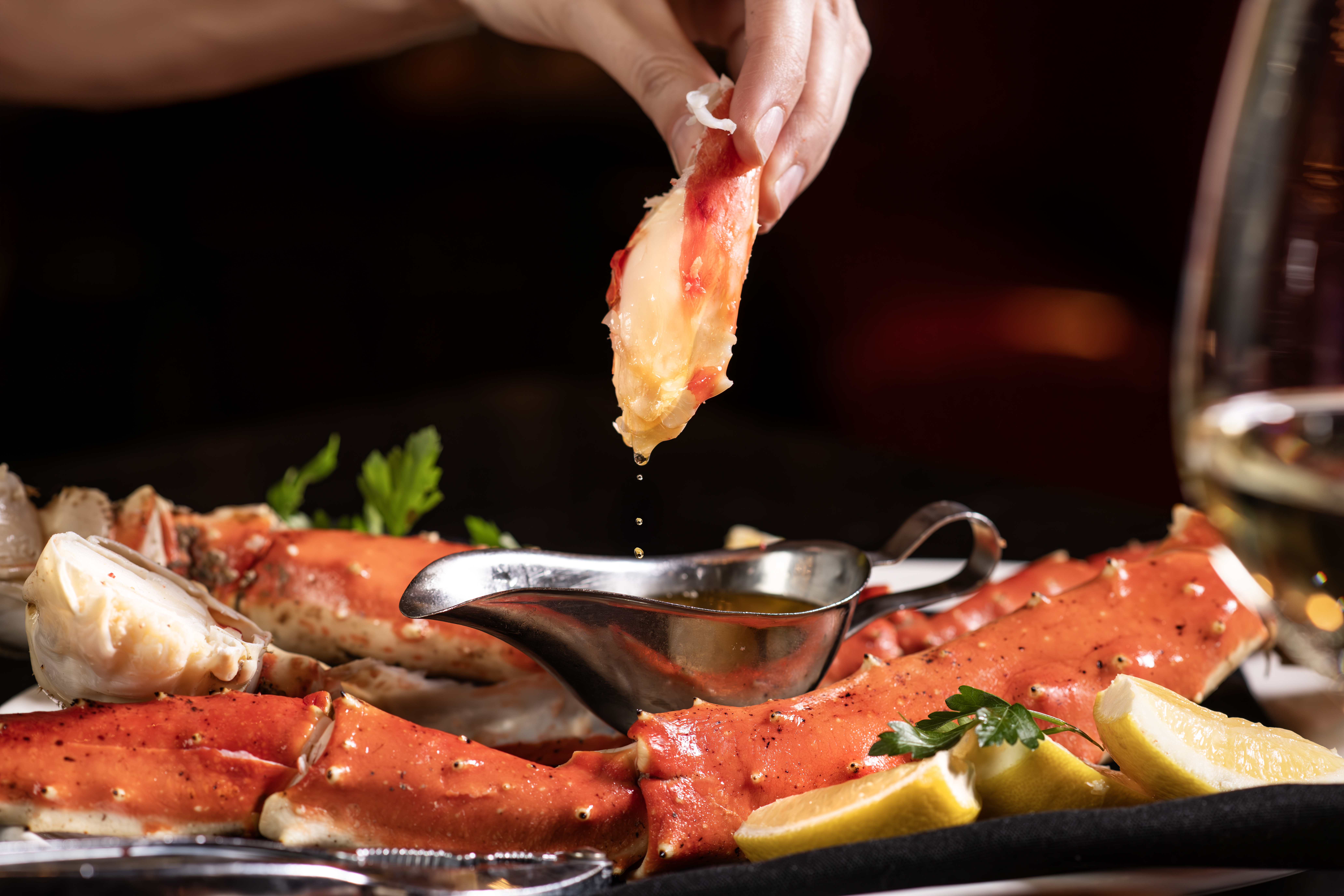 Dipping crab leg into butter